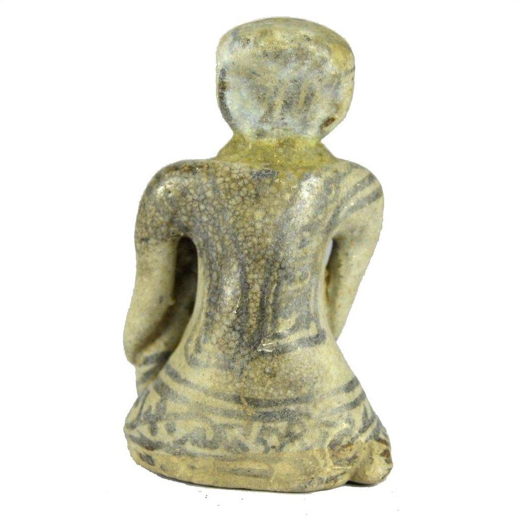 Brown glazed terracotta fertility doll miniature, seated, back view, with patterned surface details.