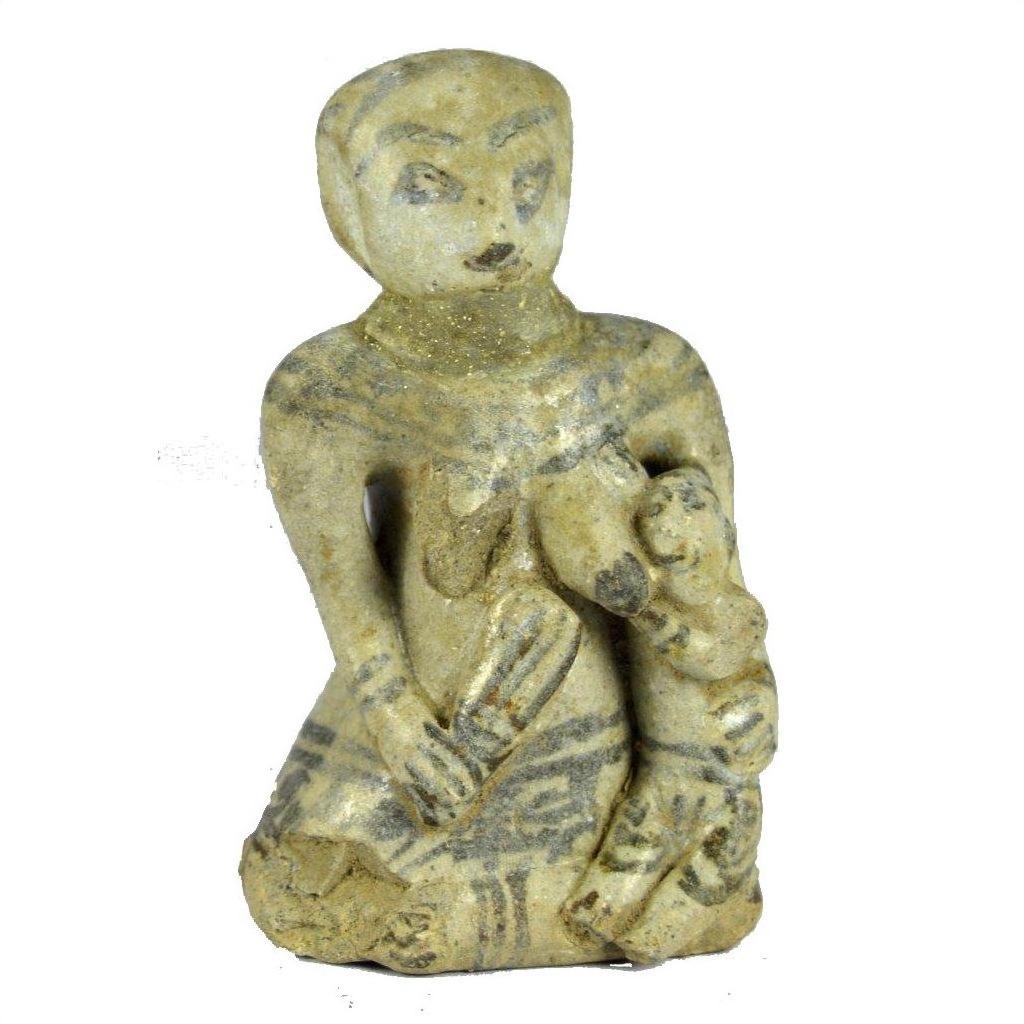 Brown glazed terracotta miniature fertility doll of a seated woman breastfeeding with painted body details, close-up.