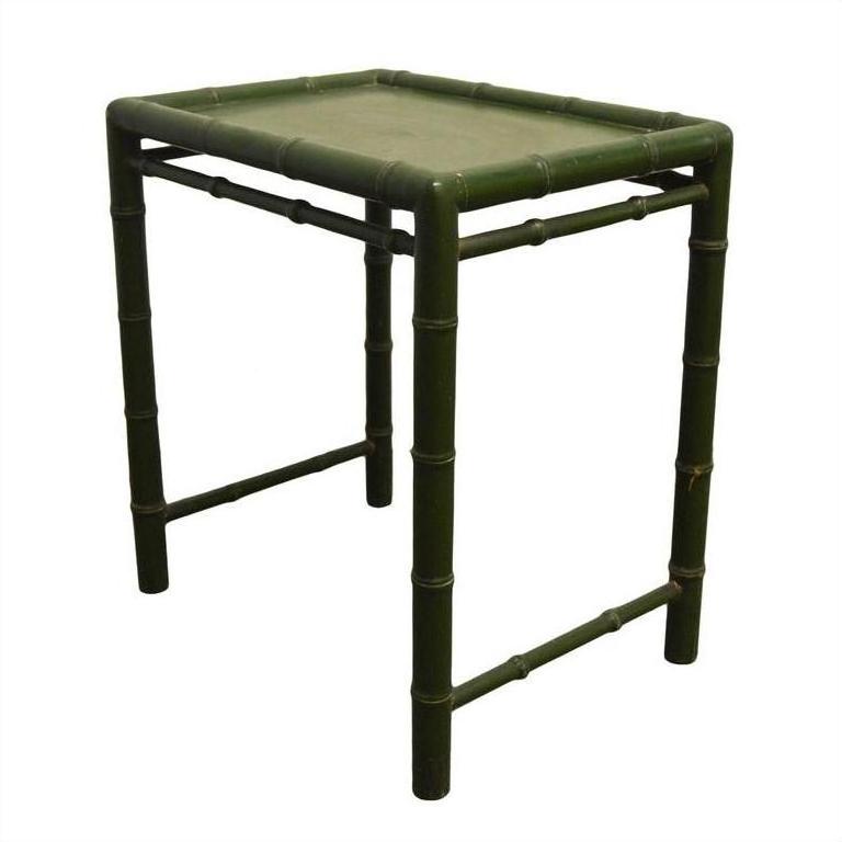 Green bamboo-style square side table with four legs, bamboo-inspired frame, close-up view against plain background.