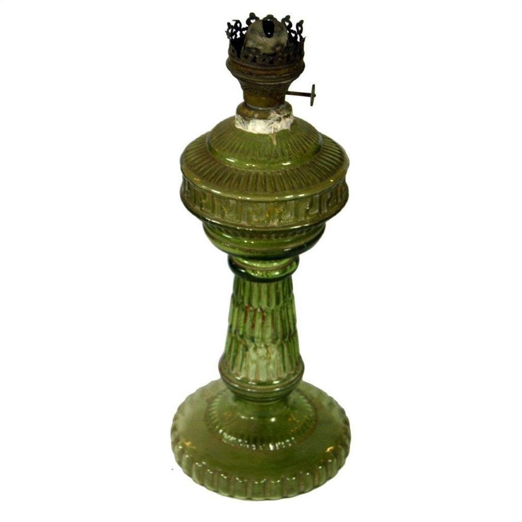Close-up of green glass oil lamp with ribbed base and brass burner, in very good condition.