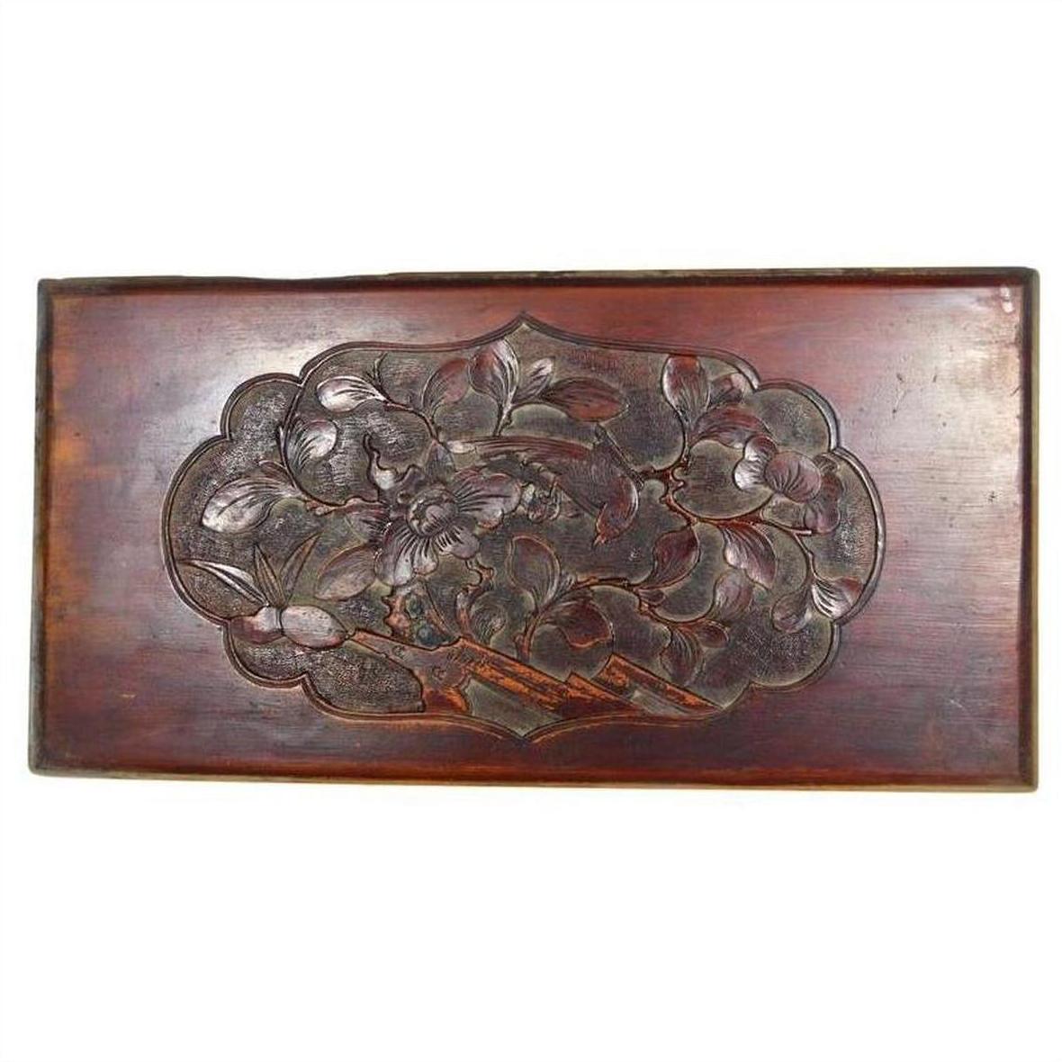 Close-up of 19th-century Chinese red lacquered rosewood wall plaque with central hand-carved bird motif.