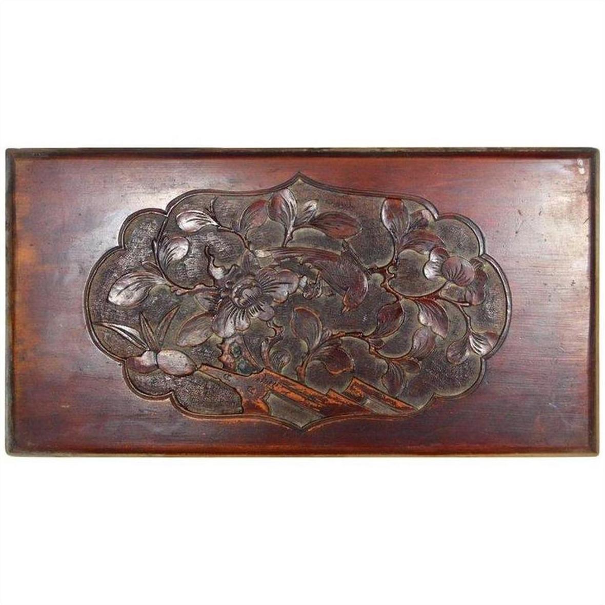Dark rosewood Chinese wall plaque, 19th century, hand-carved and lacquered with bird and ornate floral designs.