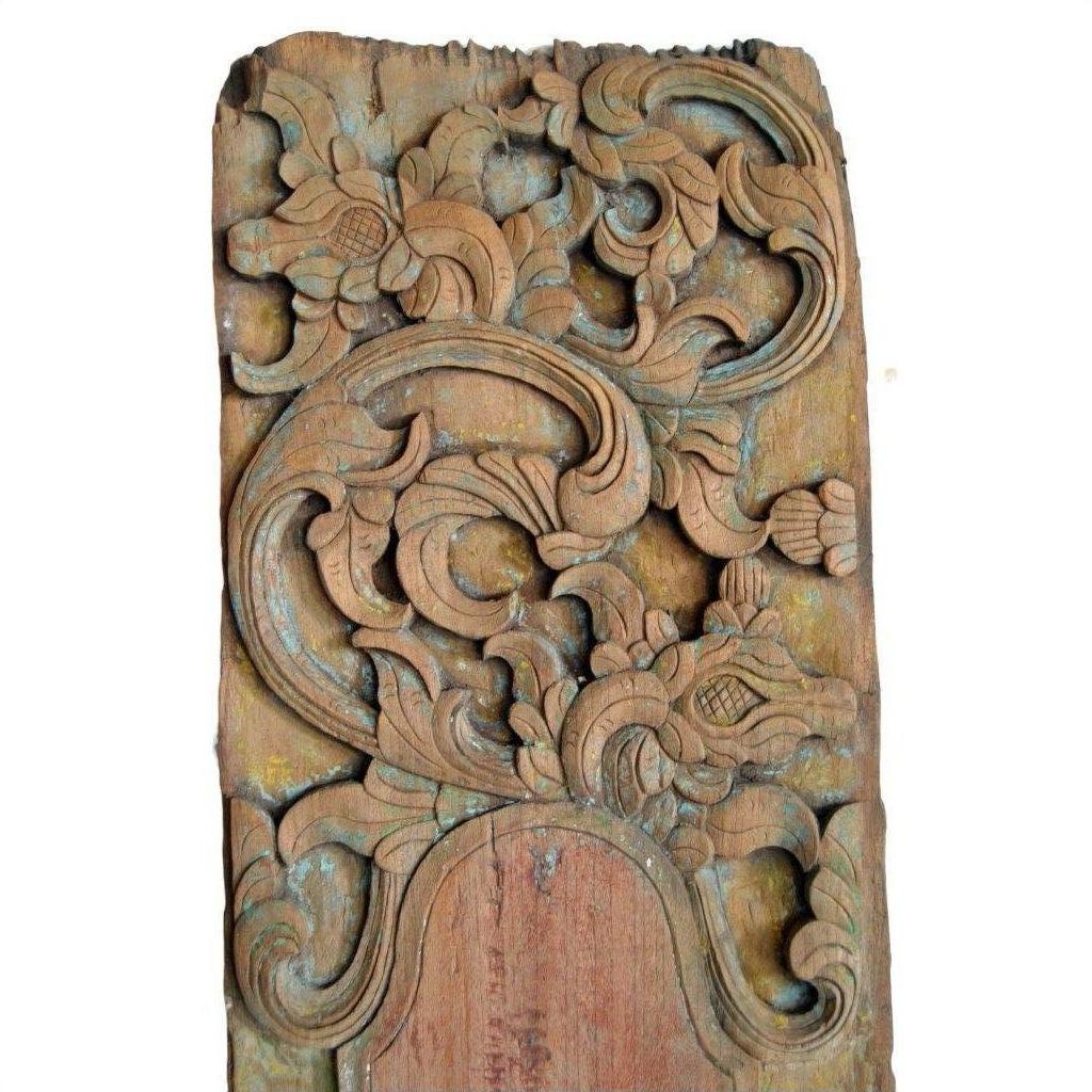 Brown wood hand carved wall plaques with ornate floral and leaf motifs, decorative style, close-up view.