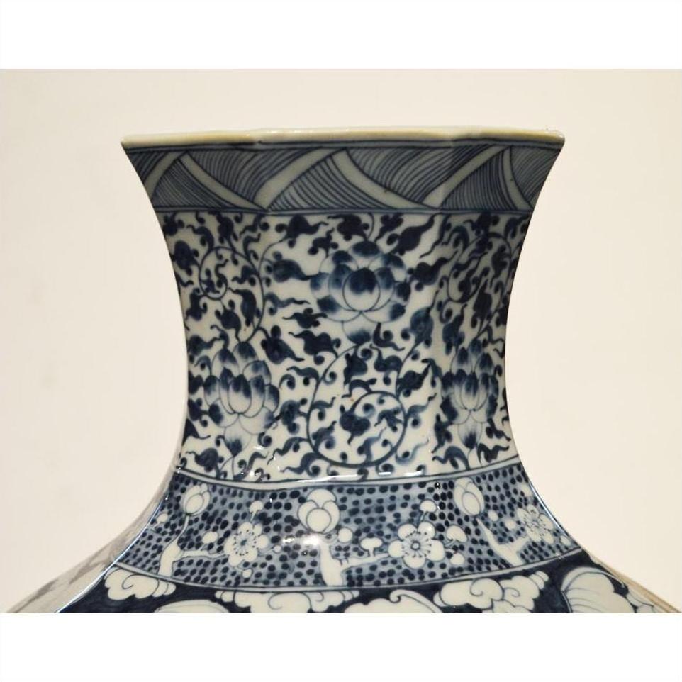 Close-up of a blue and white hand painted Chinese porcelain vase with floral and geometric patterns.
