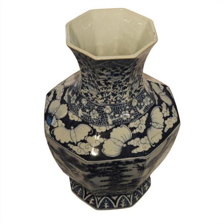 Blue and white porcelain vase with floral and cloud patterns, hexagonal shape, top view.