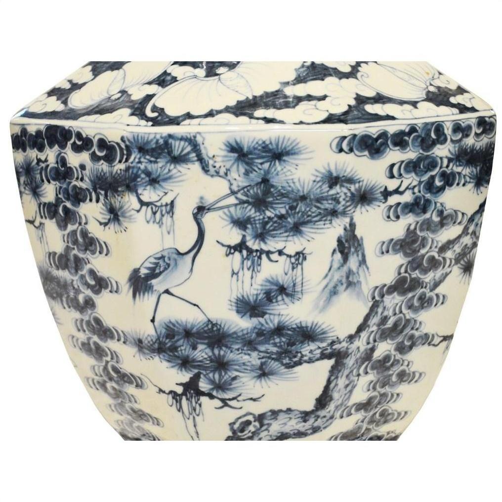Blue and white porcelain vase with hand painted crane and pine tree design in classic Asian style.