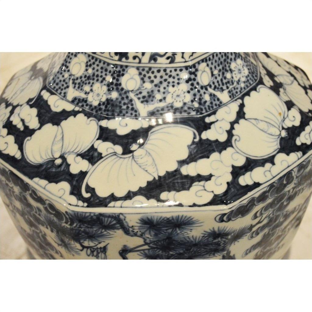 Blue and white porcelain vase with painted floral, leaf, cloud, and lotus patterns.
