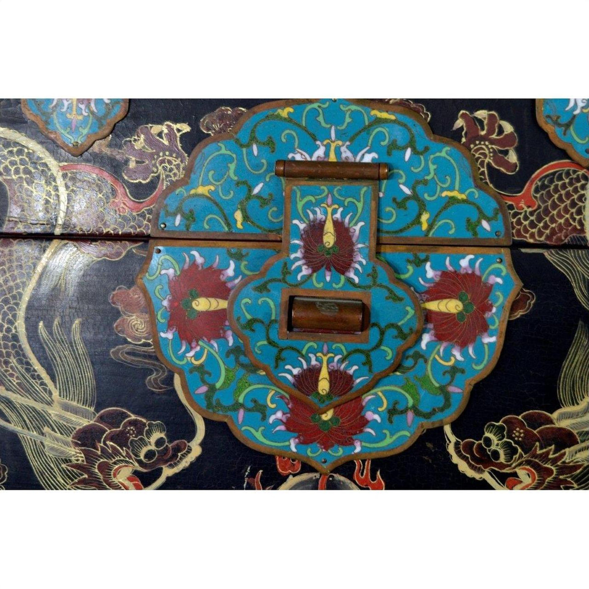 Colorful hand-painted wooden dowry box with gold floral and phoenix designs, close-up of decorative lock plate.