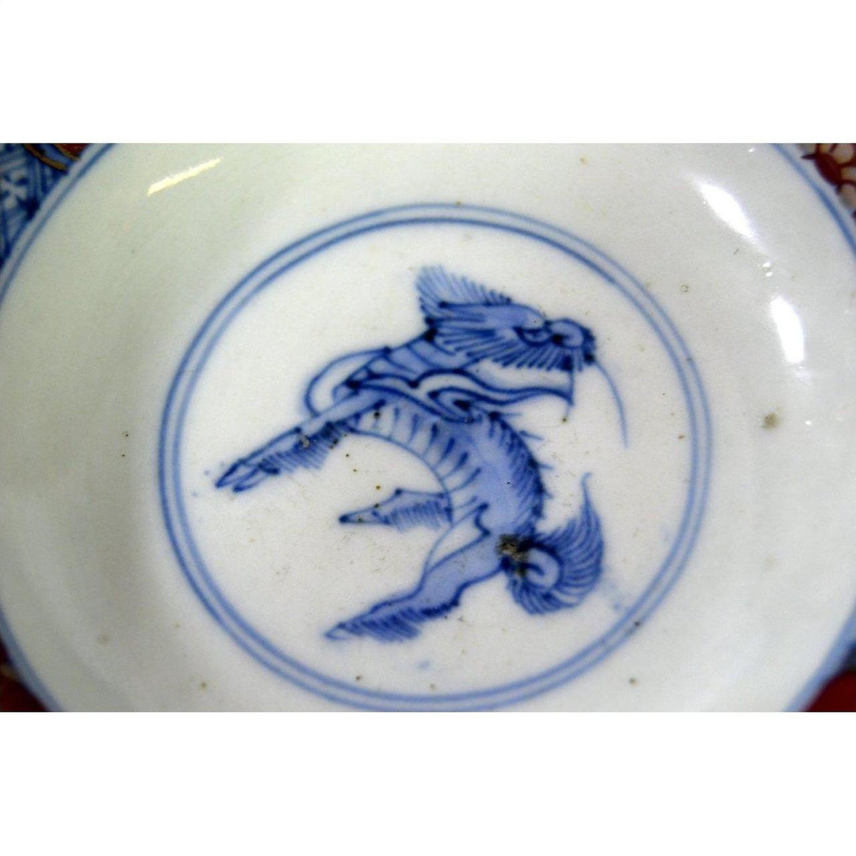 White porcelain Imari small plates with hand-painted stylized bird design, set of 6, close-up view.