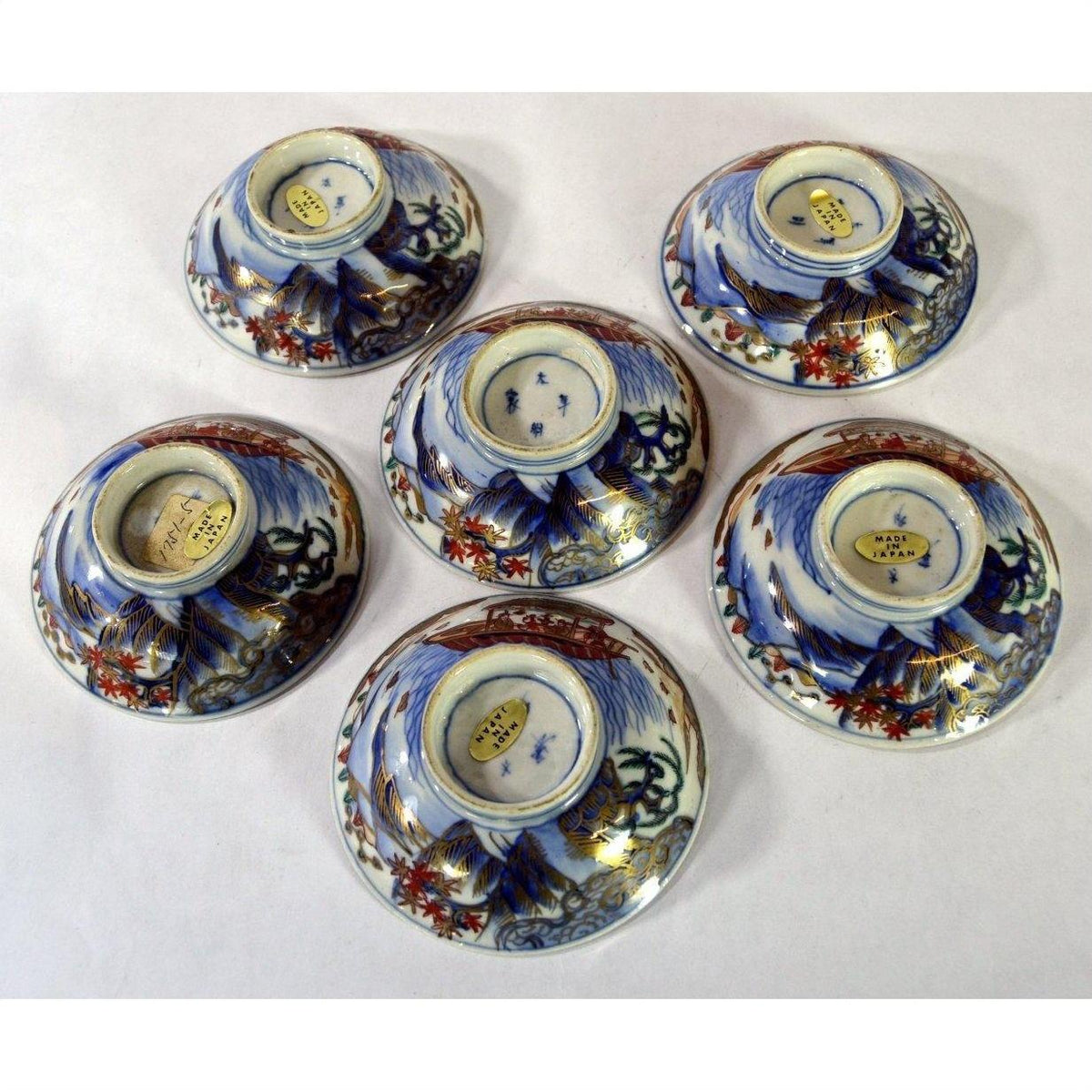 Blue, red, and gold hand painted Imari porcelain small plates set of 6, displayed on white background.