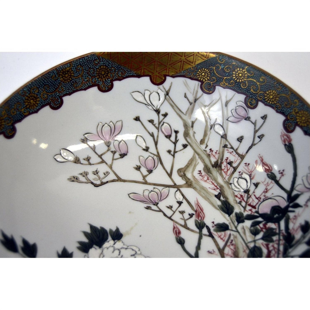 Close-up of hand painted Kutani porcelain bowl with pink blossoms and gold maroon border, 7-inch diameter.