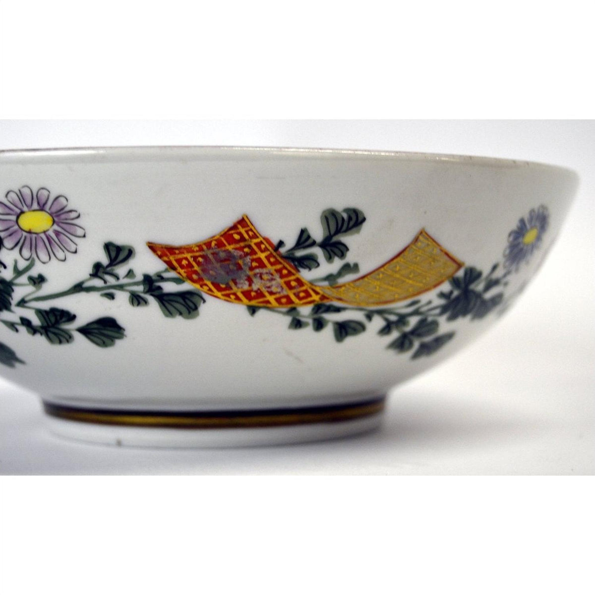 Red, yellow, and green porcelain bowl with floral and geometric patterns, 7 inch diameter.