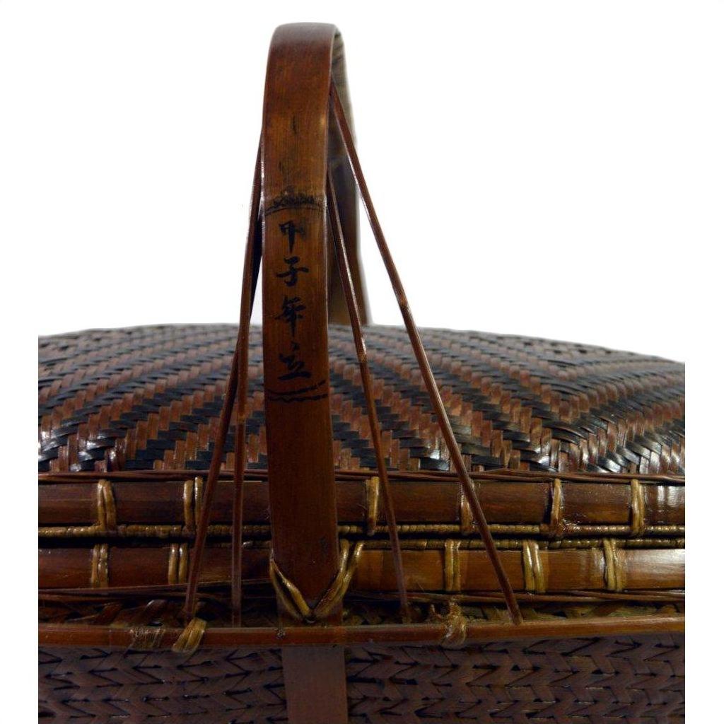 Close-up of a handwoven rattan basket with handle in natural color, featuring black Chinese characters.