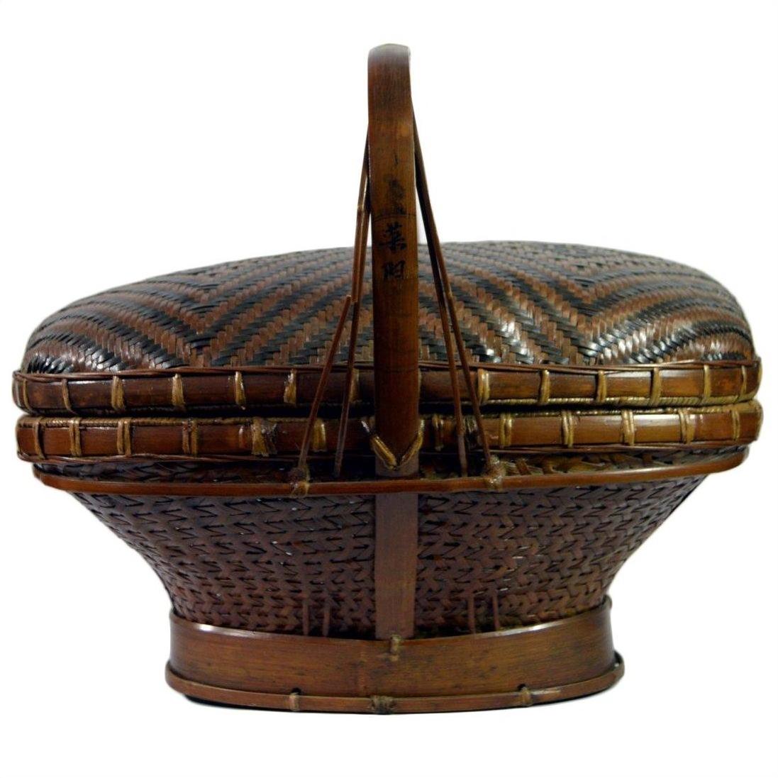 Natural rattan basket with lid, handle, and intricate woven patterns, shown in very good condition.