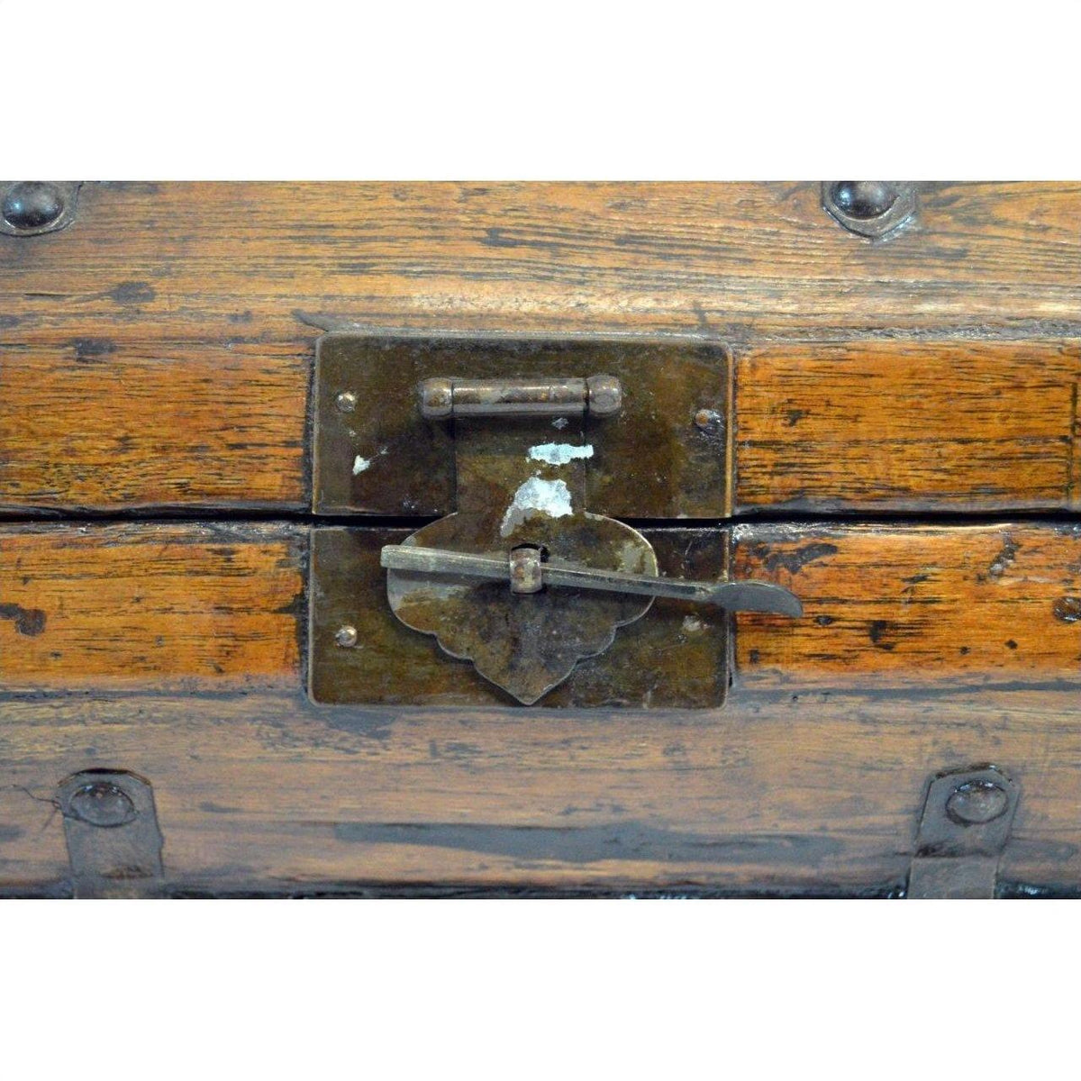 Close-up of brown lacquered hinged Chinese box with iron hardware and central metal latch.