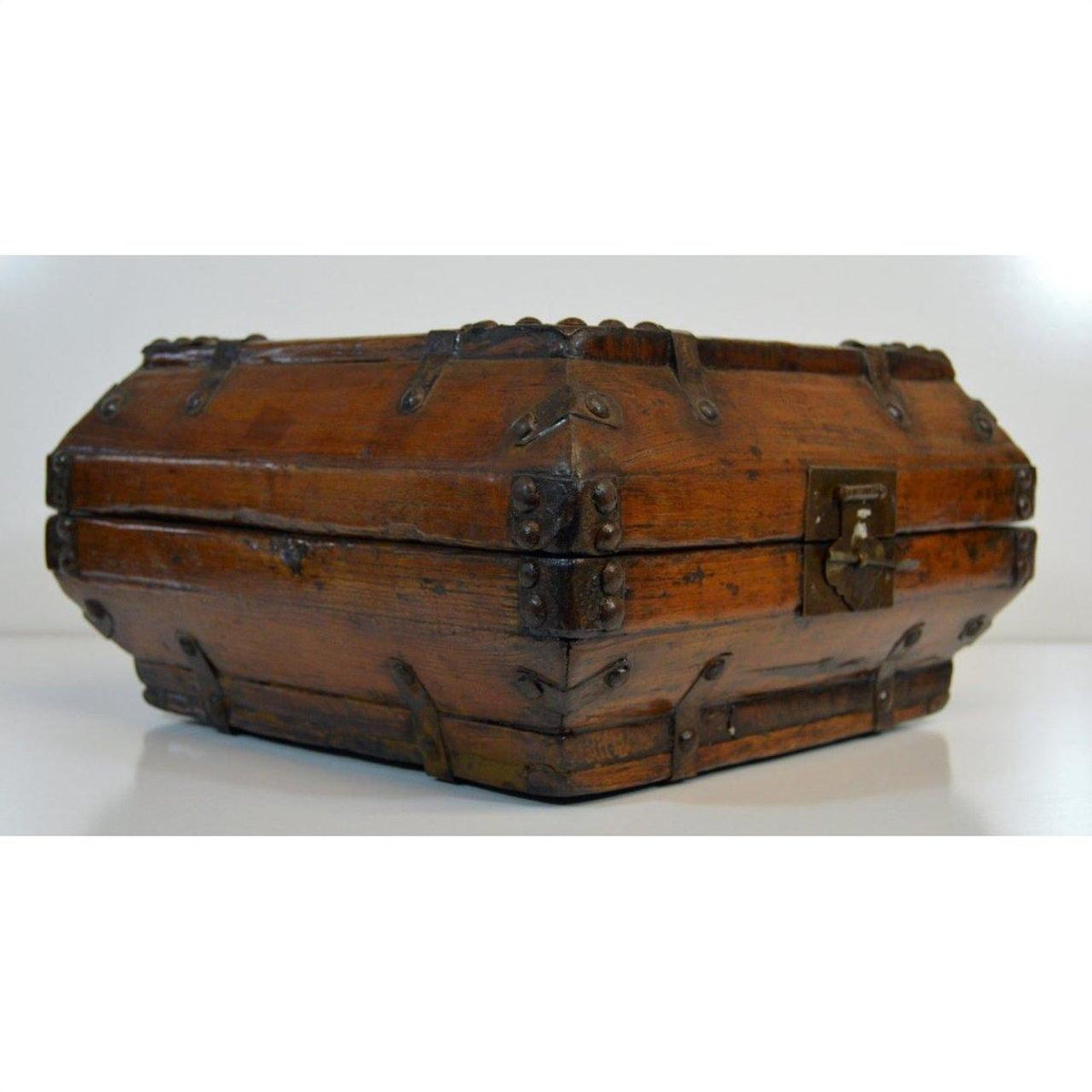 Brown lacquered Chinese box with iron hardware on white surface.