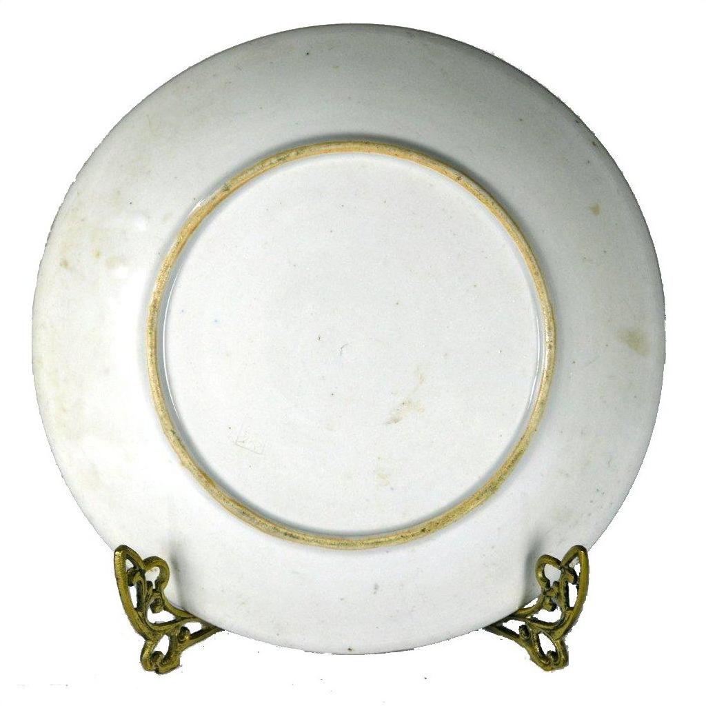 White Igezara transferware plate with gold rim on a metal stand, Meiji Period style, close-up view.