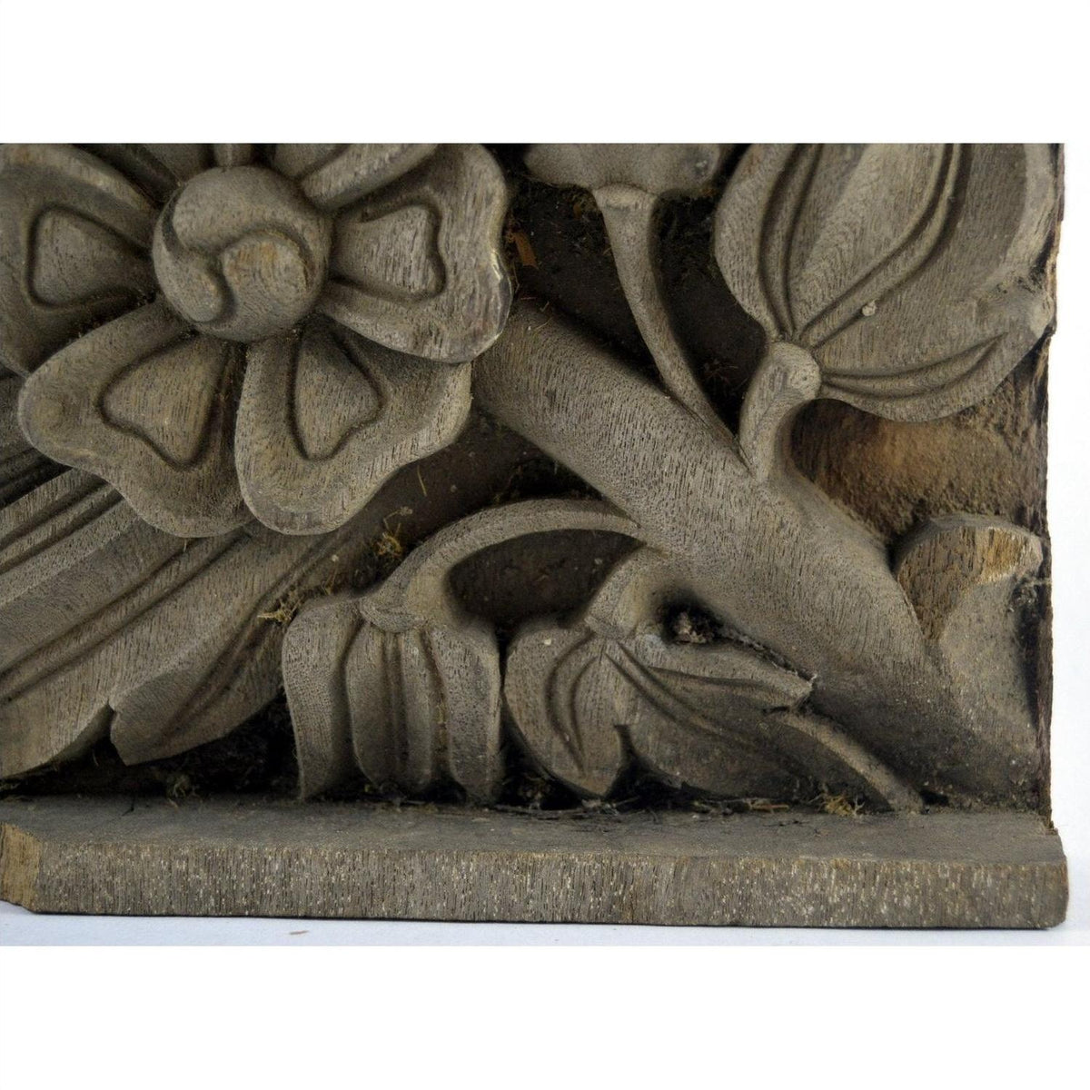 Brown carved wood plaque with flower and leaf design, rectangular, shown against a plain background.