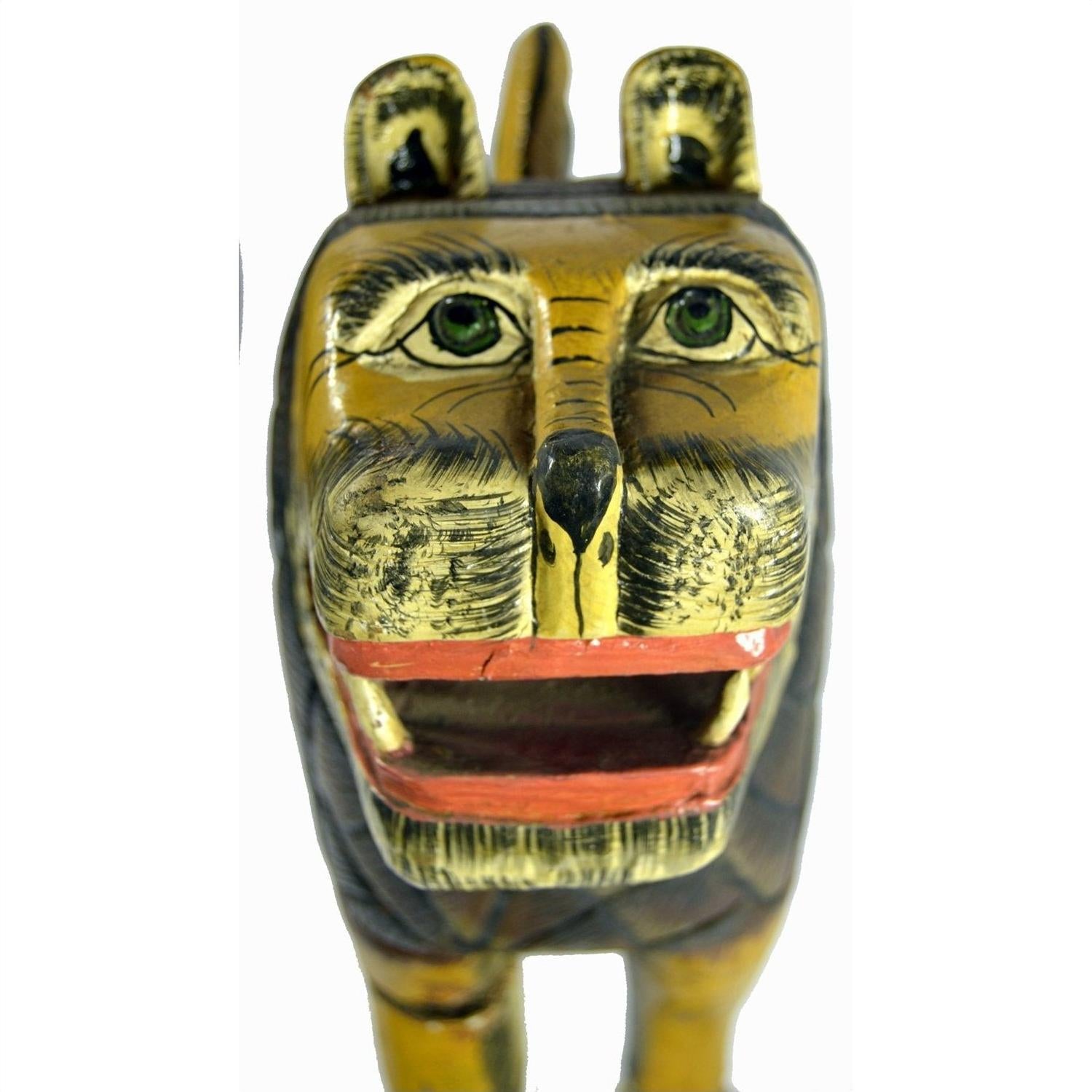 Brown painted wood hand-carved lion with green eyes, black stripes, and open mouth, close-up, good condition.