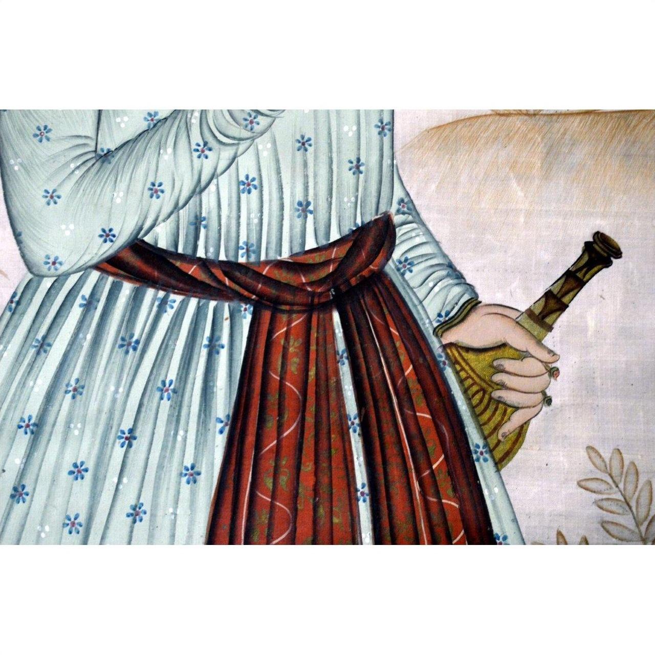 Person in a patterned dress with red sash holding an India silk tapestry, all items in very good condition.