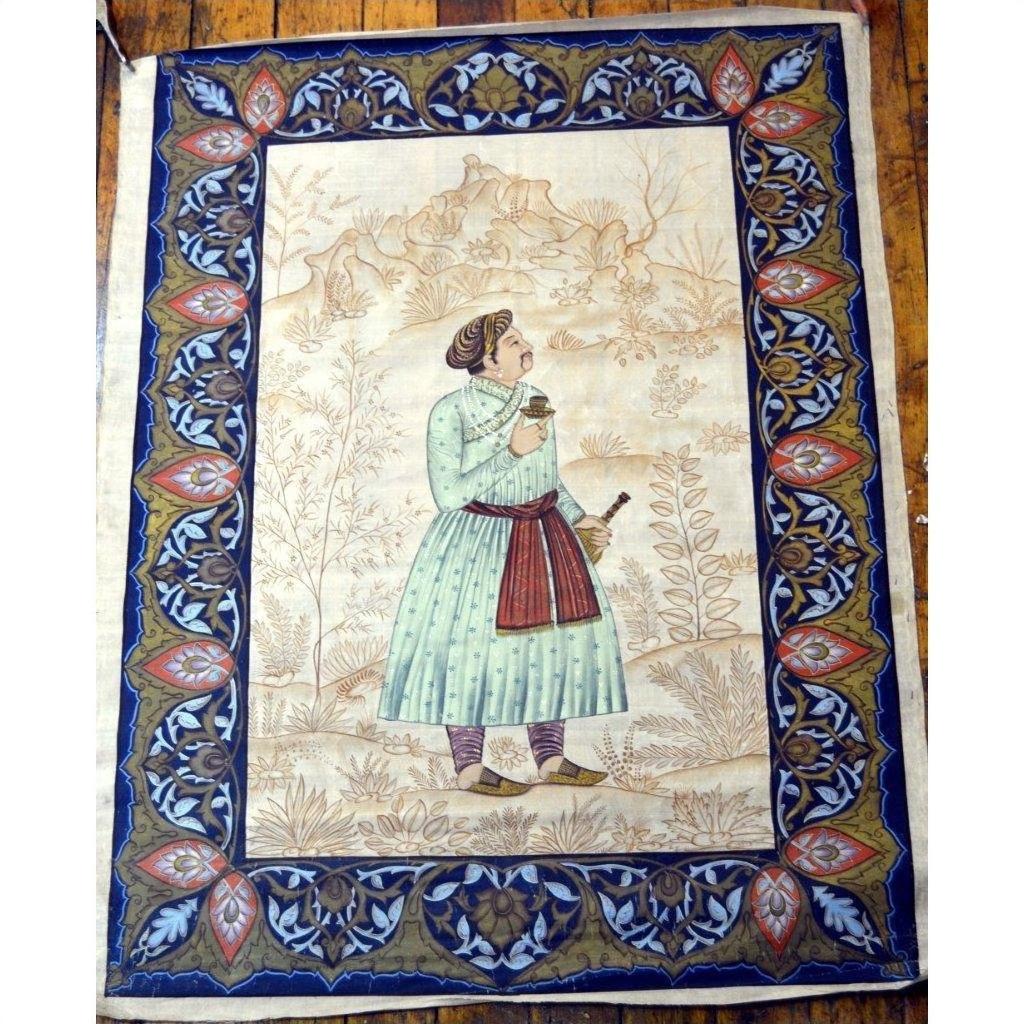 Blue and gold silk tapestry featuring Mughal-style nobleman with ornate floral border, in very good condition.