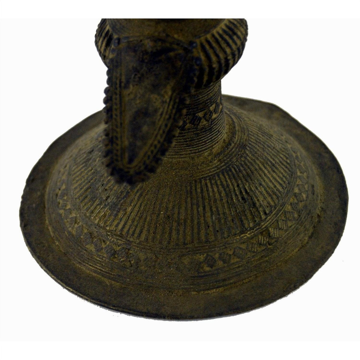 Close-up of an Indian brass oil burner showing intricate patterns and a raised, pointed center.