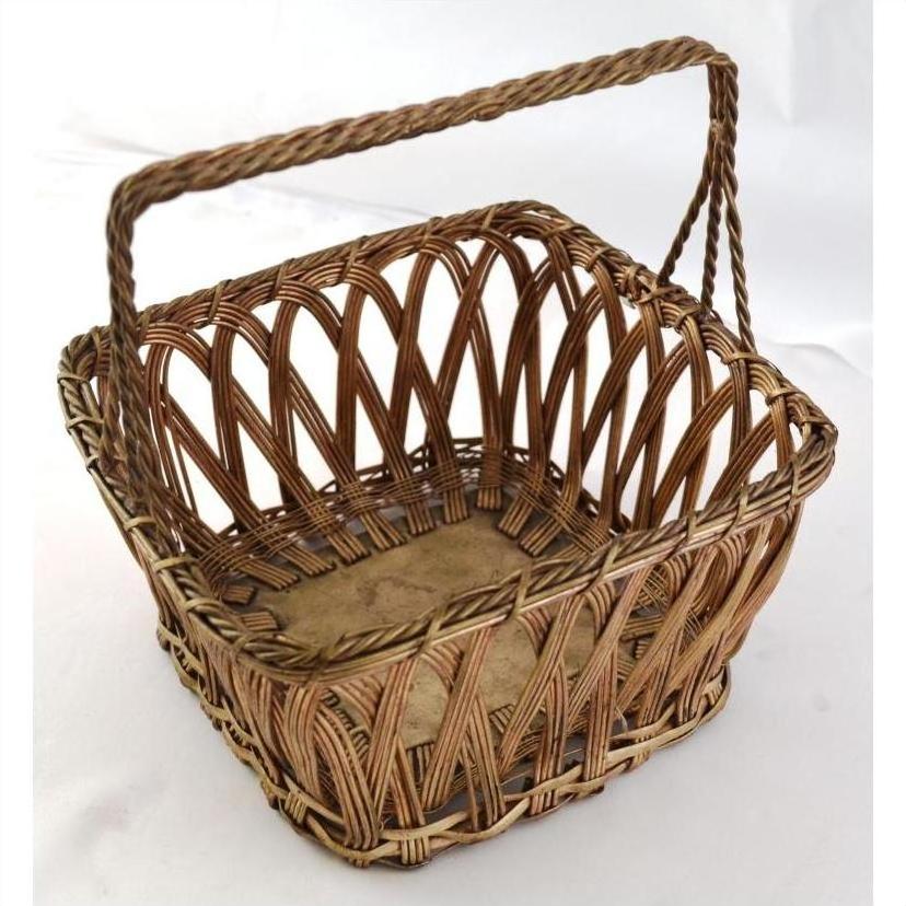 Square silver nickel wire woven basket with arched handle on a light background.