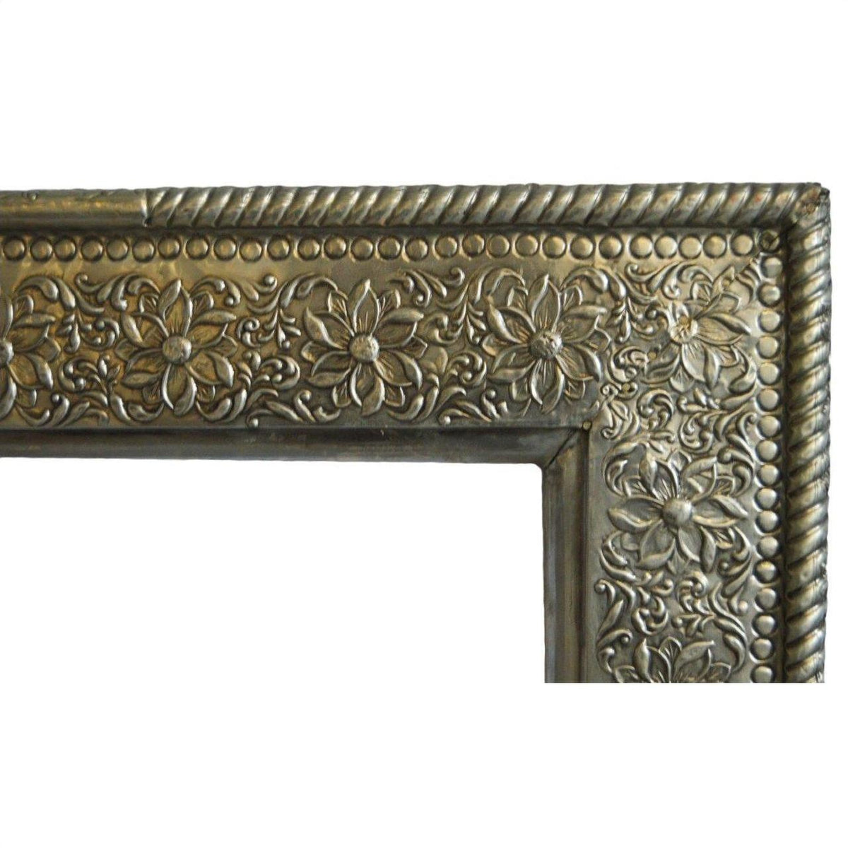 Silver-nickel Indian repoussé rectangular frame with embossed floral and rope designs, displayed on white background.
