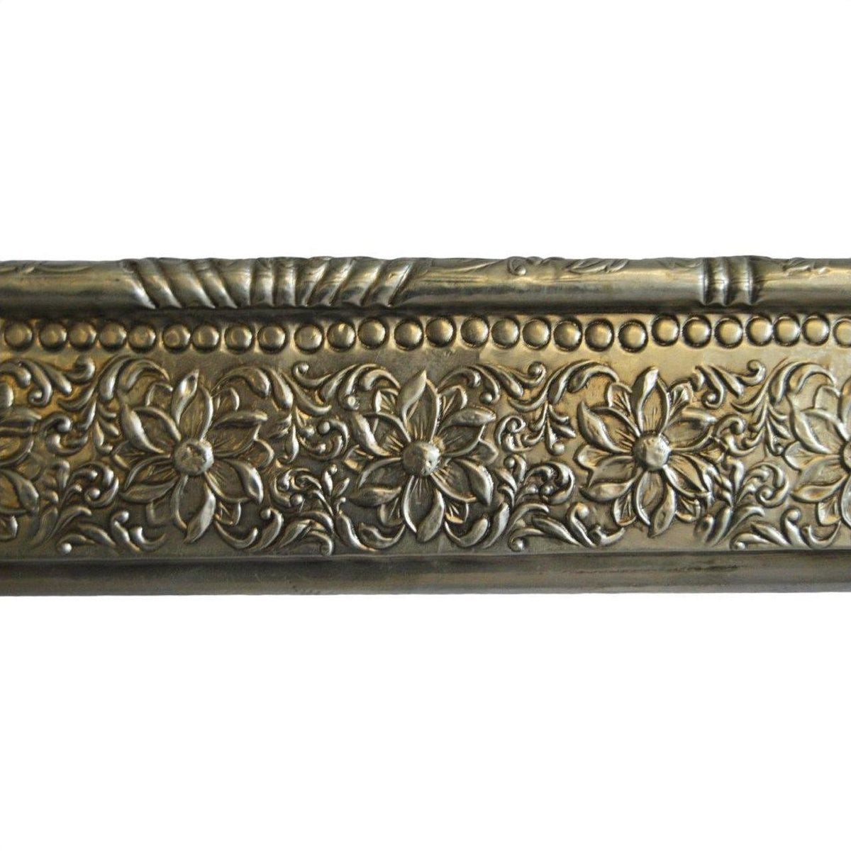 Silver metal Indian repoussé rectangular frame with embossed repeating floral and vine motifs, close-up view.