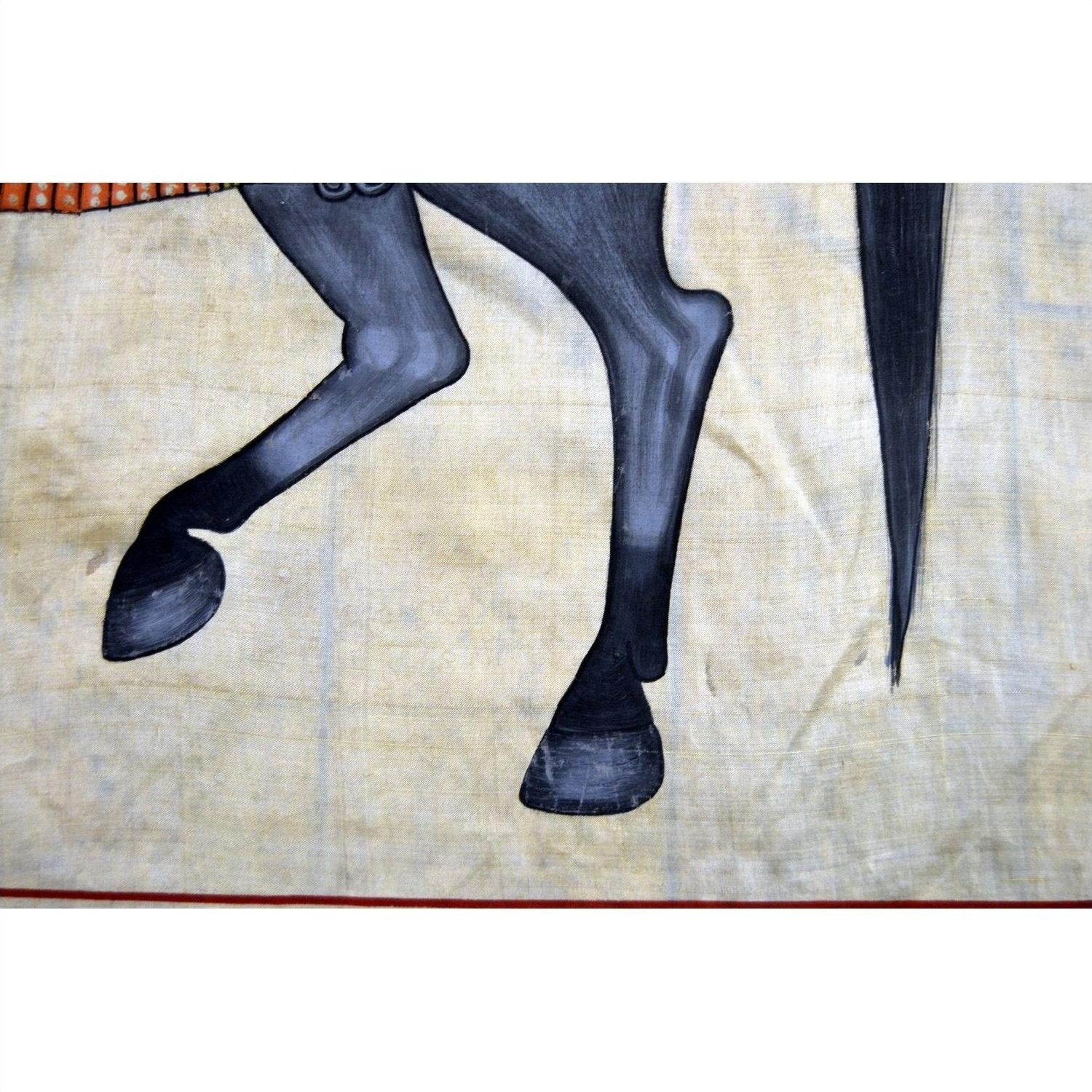 Beige fabric tapestry with black-legged horse, some paint loss, measures 33.5 x 22.5 inches.