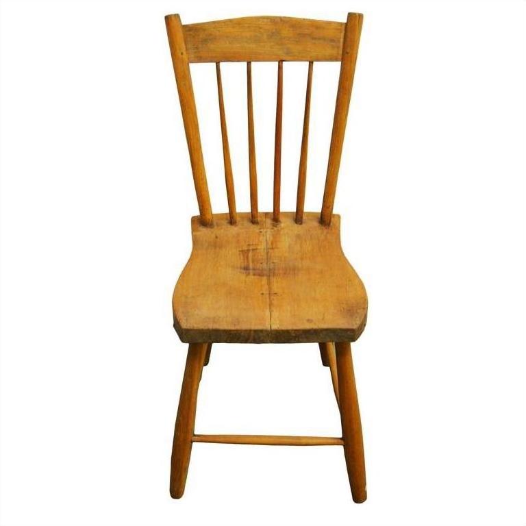 Brown wood Indonesian chair with curved backrest and vertical slats, front view on white background.