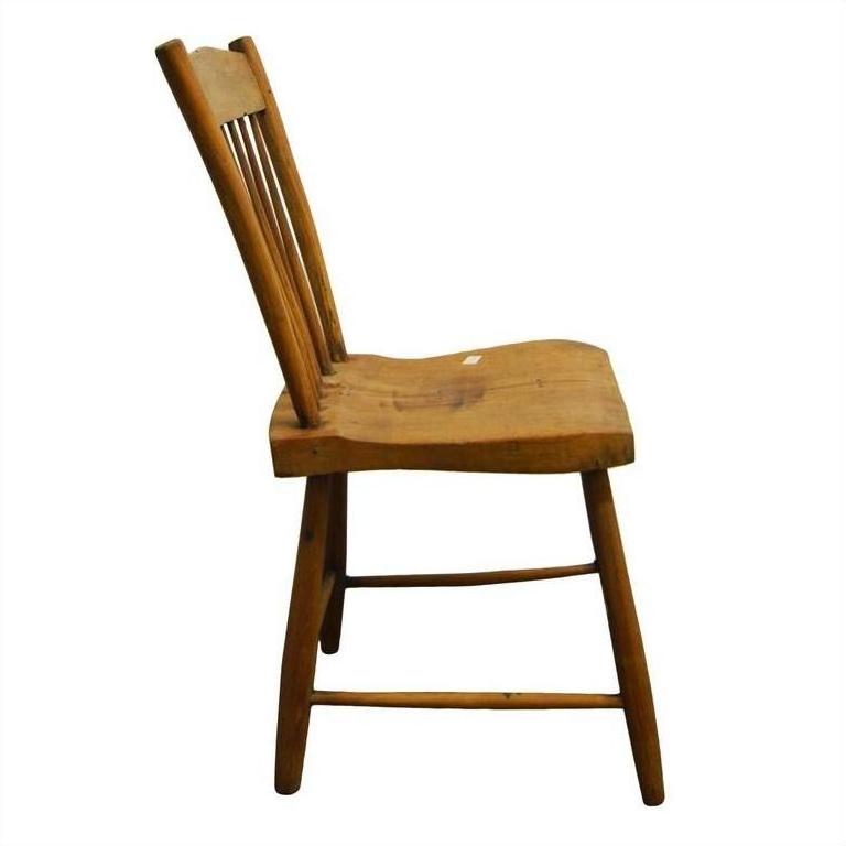 Light wood chair with slatted back, side view, minimalist design, set against a plain white background.