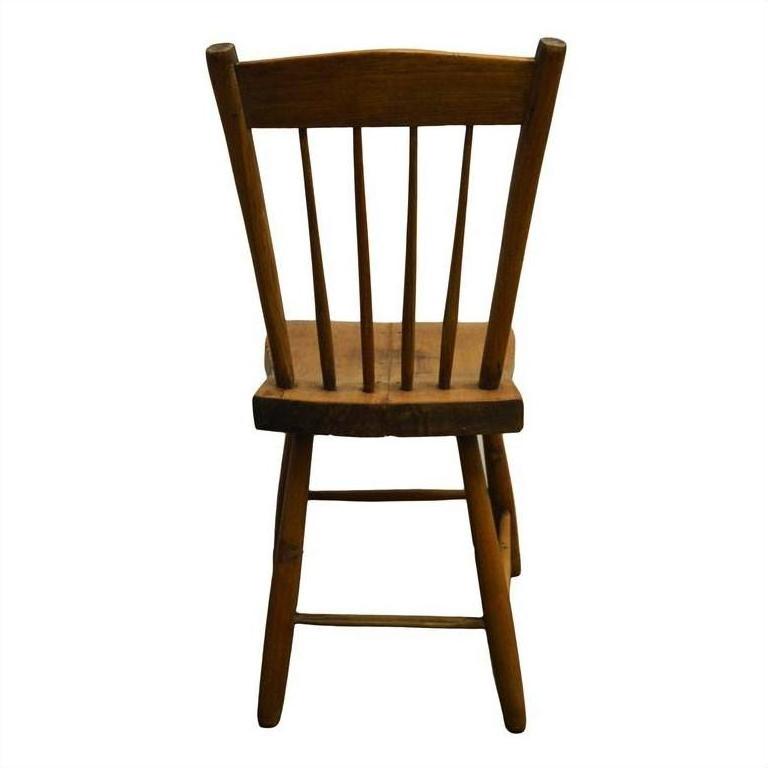 Brown wooden chair with slatted backrest, rear view, on a white background.