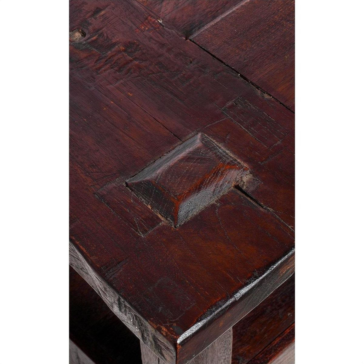 Close-up of a natural stain wood Indonesian coffee table corner with visible grain and raised rectangular joint detail.