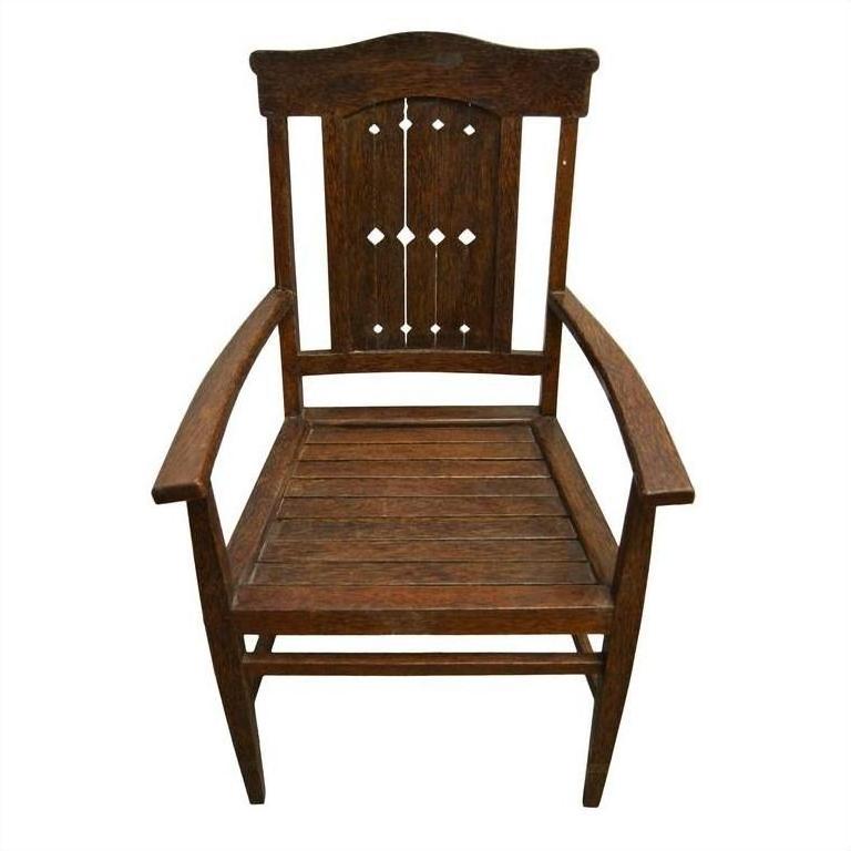 Brown wooden vintage armchair with high back and diamond cut-out pattern on the back panel, Indonesian Java style.