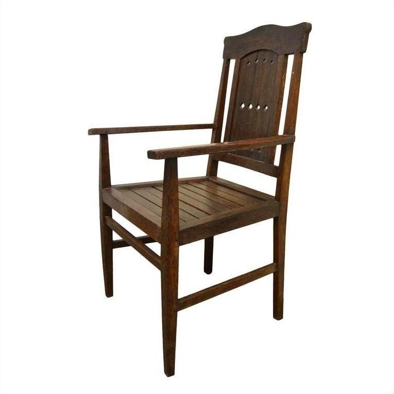 Dark wood armchair with slatted seat and diamond cut-out backrest on white background.