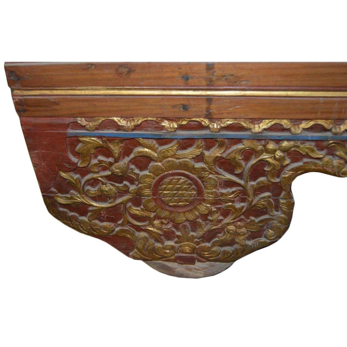 Reddish-brown wood chest with gold floral motifs and central circle, traditional design, no visible setting.