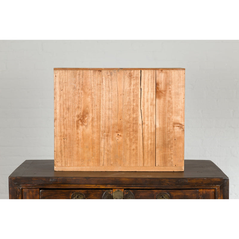 This-is-a-picture-of-a-Japanese Antique Kiri Wood Miniature Tansu Chest with Sliding Doors and Drawers-image-position-17-style-YN7731-Shop-for-Vintage-and-Antique-Asian-and-Chinese-Furniture-for-sale-at-FEA Home-NYC