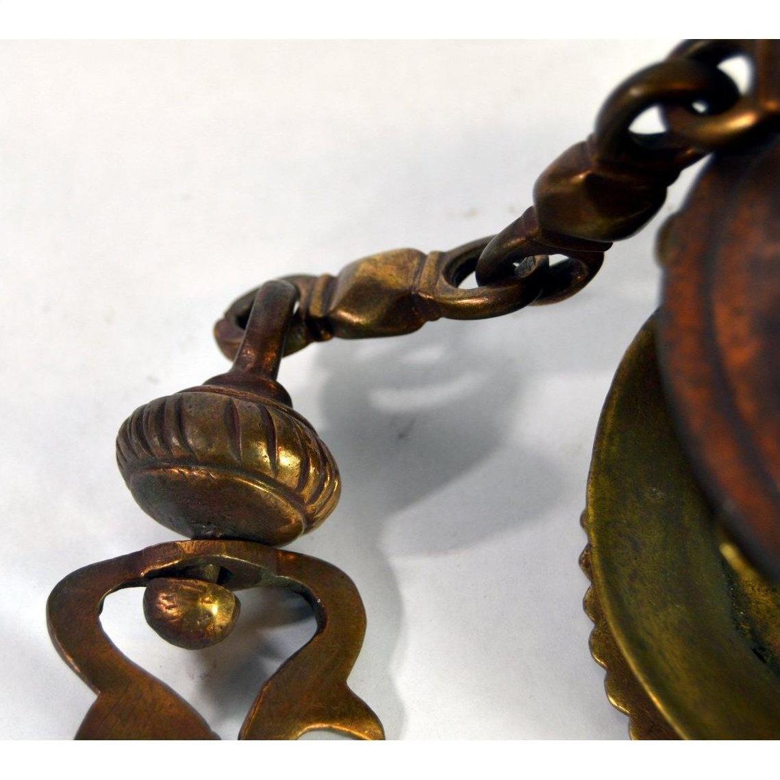 Close-up of vintage brass Japanese temple incense burner with ornate metalwork and decorative clasp, 19 inches long.
