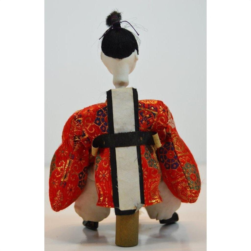 Red and gold kimono Japanese doll with white and black obi, Kyoto-made, Taisho period, rear view.
