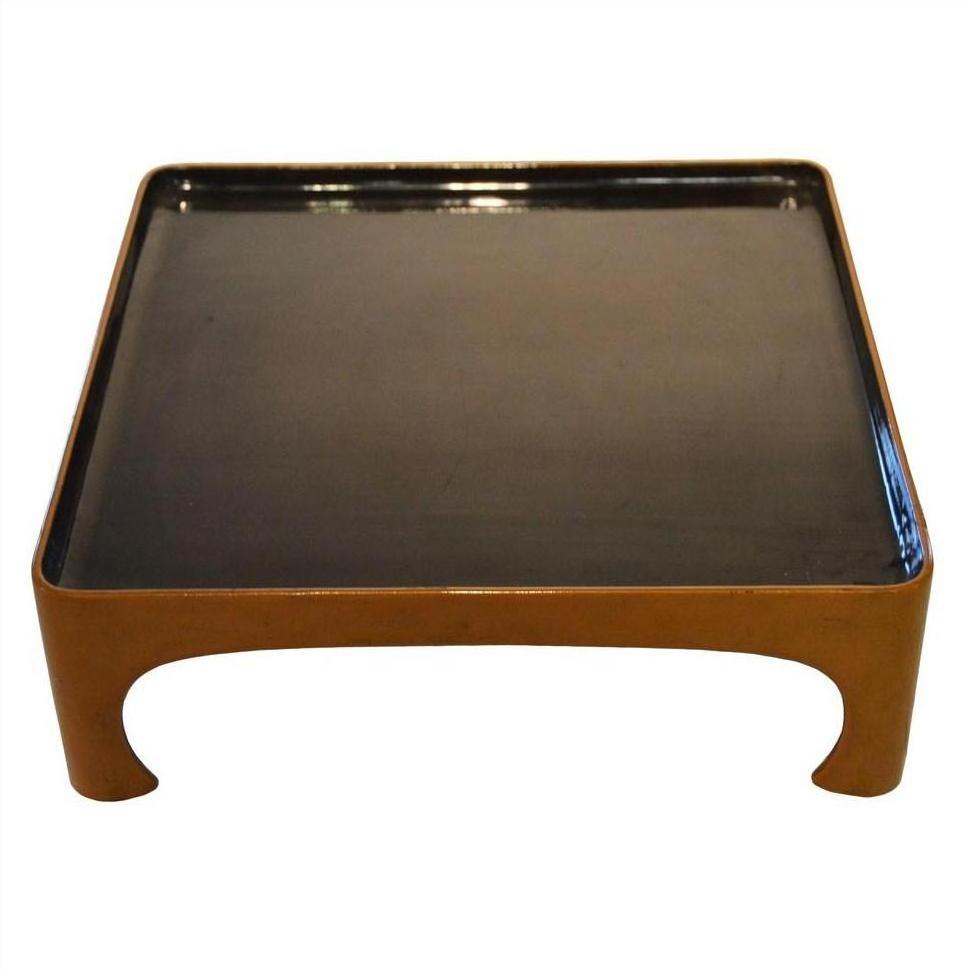 Black lacquered bamboo square tea ceremony tray with curved legs and raised edges, close-up.