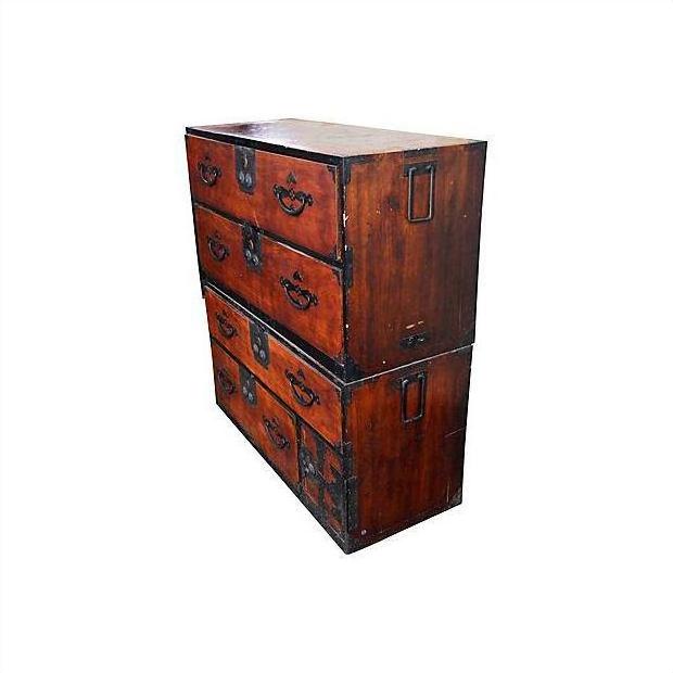 Brown Keyaki wood Isho-Dansu chest with metal handles, antique Japanese furniture against a white background.