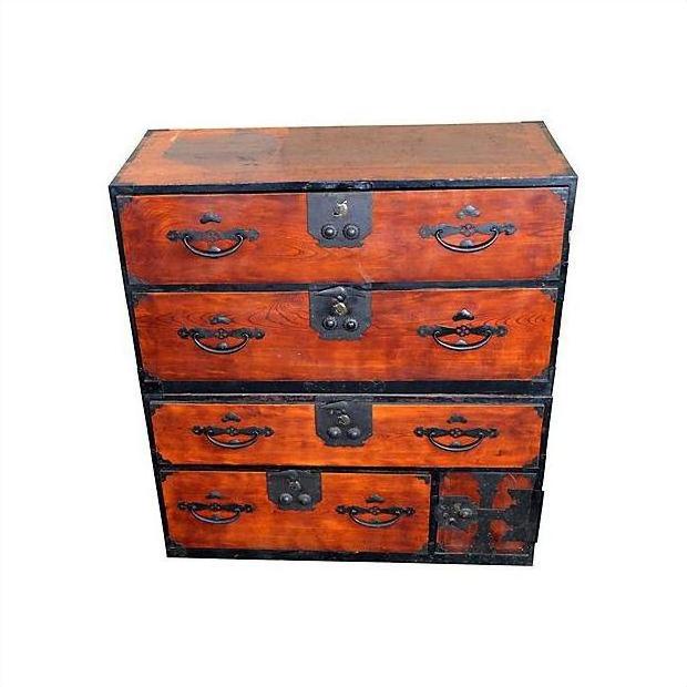 Brown Keyaki wood Isho-Dansu chest with black metal handles and four drawers, antique Japanese furniture.