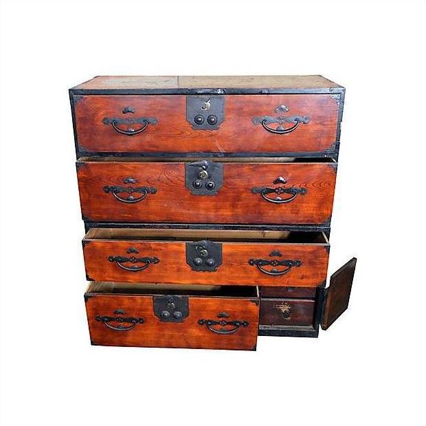 Brown Keyaki wood Isho-Dansu clothing chest with four drawers, two drawers open, side door partially open.