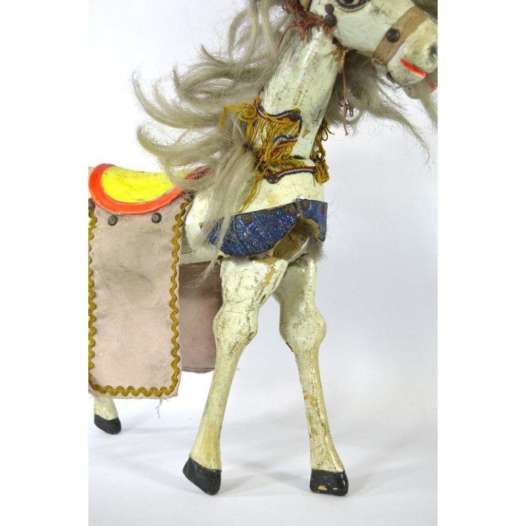 Vintage Japanese two-headed horse toy with yellow and red saddle, blue harness, gray mane, side view.