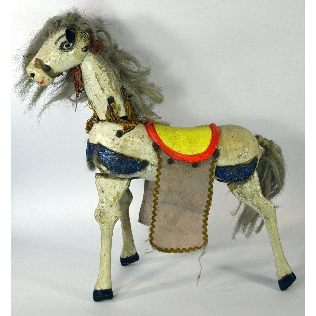 Plastic two-headed horse toy with yellow saddle, gray mane and tail, blue and red accents, shown on plain background.