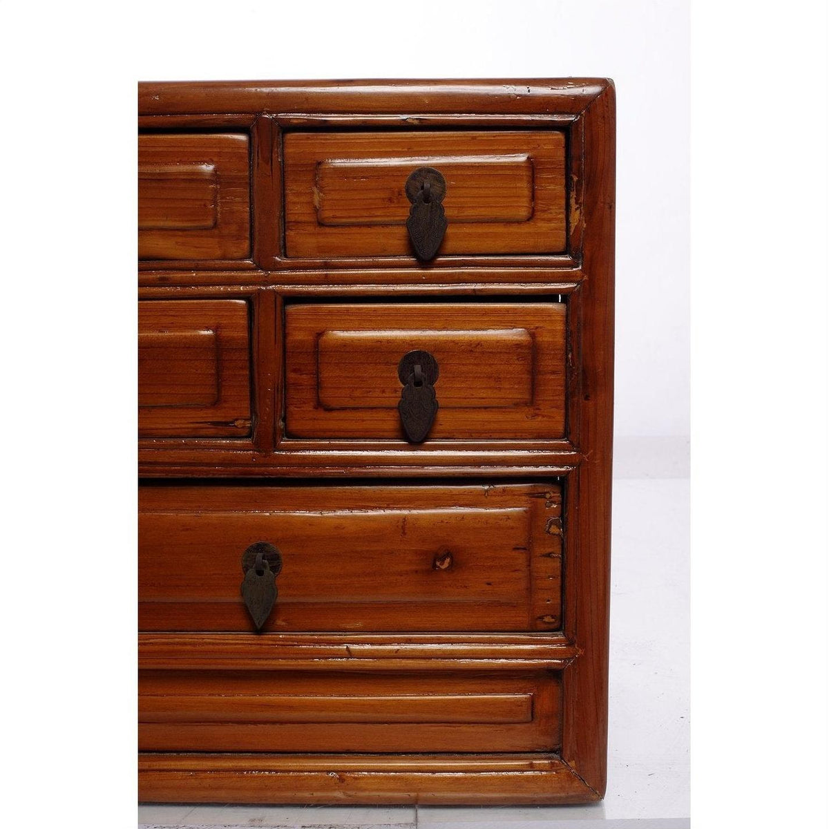 Wooden jewelry box with five drawers and metal keyhole plates, displayed on a white background.