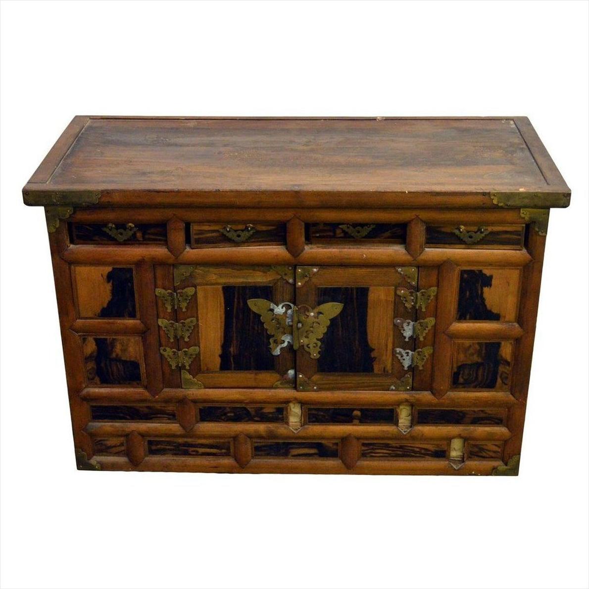 Dark wood antique Korean chest with ornate front panels, butterfly brass hardware, 19th-century design, close-up view.