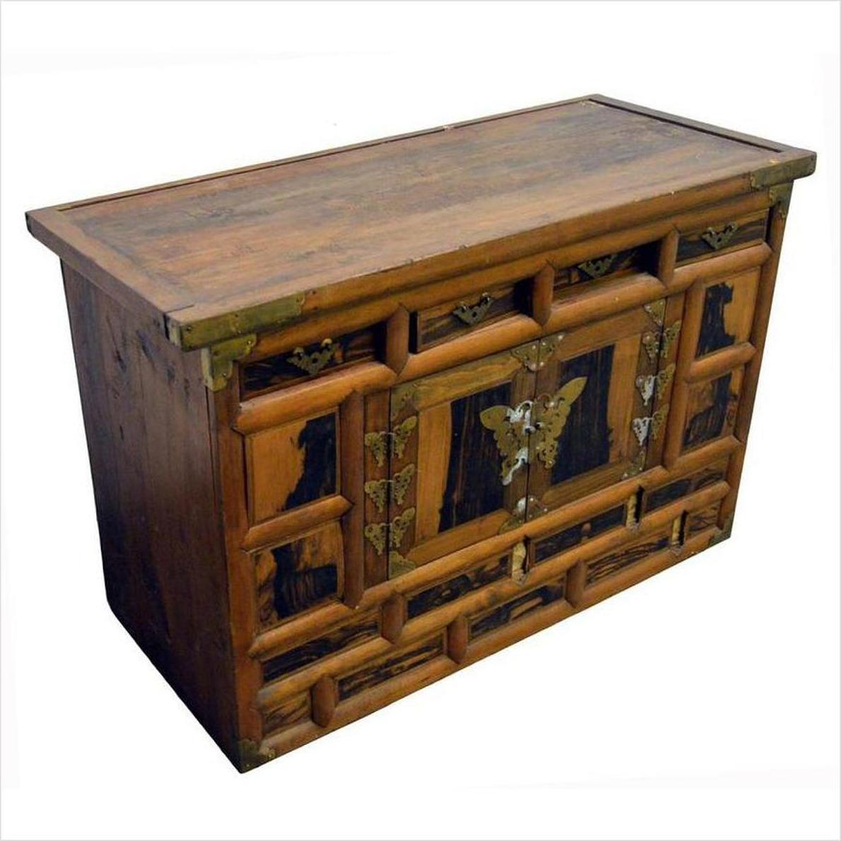 Dark wood chest with brass butterfly hardware, ornate front hinges, and multiple drawers, 19th century.