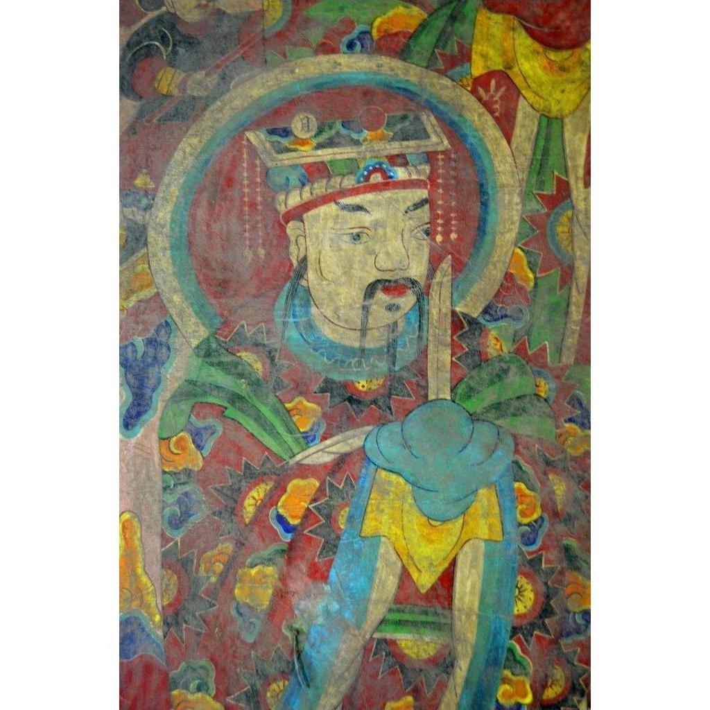 Colorful parchment painting of Laotian emperor in ornate robes, double plexiglass frame, close-up view.